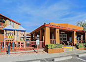 Thumbnail 18 of 22 - A building with a red roof and a blue awning is in the image.