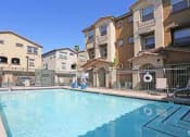 Thumbnail 13 of 14 - a large swimming pool in front of some apartment buildings