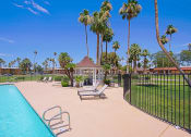 Thumbnail 4 of 21 - a pool with a gazebo and palm trees in the background