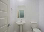 Thumbnail 6 of 14 - a bathroom with a sink toilet and a mirror