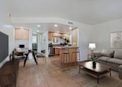 Thumbnail 4 of 20 - A modern living room with a kitchen in the background.