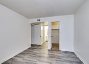Thumbnail 13 of 17 - the living room of an apartment with white walls and wood flooring
