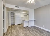 Thumbnail 11 of 17 - an empty living room and kitchen with a white refrigerator and