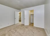 Thumbnail 10 of 17 - an empty living room with white walls and carpeting