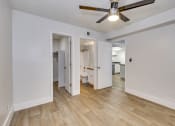 Thumbnail 17 of 17 - a living room with white walls and a ceiling fan