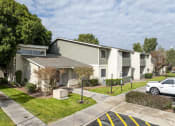 Thumbnail 4 of 17 - an apartment building with a white truck parked in front of it