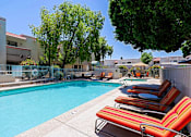 Thumbnail 52 of 94 - A pool surrounded by chairs and trees.
