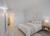 Thumbnail 3 of 18 - A bedroom with a large bed and a nightstand.
