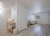 Thumbnail 7 of 18 - A room with a wooden floor and white walls.