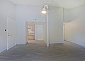 Thumbnail 24 of 24 - A room with a light hanging from the ceiling and a door on the left at Connect on Northern, Glendale, AZ
