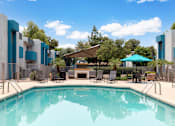 Thumbnail 6 of 15 - A swimming pool in front of a modern building.