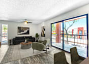 Thumbnail 2 of 18 - A living room with a black couch, a grey armchair, a coffee table, and a ceiling fan at Tela Verde Apartment Homes, Glendale, 85306