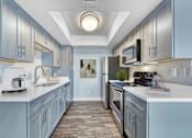 Thumbnail 4 of 18 - A kitchen with a white counter top and a sink at Tela Verde Apartment Homes, Glendale, 85306