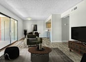 Thumbnail 3 of 18 - A modern living room with a black bean bag chair and a wooden coffee table at Tela Verde Apartment Homes, Glendale