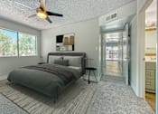 Thumbnail 9 of 18 - A bedroom with a bed and a ceiling fan at Tela Verde Apartment Homes, Glendale