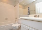 Thumbnail 7 of 9 - a bathroom with a toilet sink and bathtub