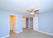 Thumbnail 6 of 9 - a bedroom with blue walls and a ceiling fan