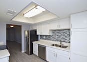 Thumbnail 2 of 9 - a kitchen with white cabinets and a stainless steel refrigerator