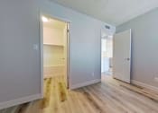 Thumbnail 14 of 16 - A room with a white door and a white wall.