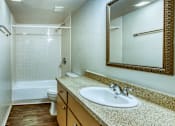 Thumbnail 10 of 14 - A bathroom with a sink, mirror, and bathtub. at The Link Apartments, Mesa, AZ, 85201
