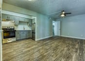 Thumbnail 2 of 14 - A kitchen with wooden floors and a ceiling fan. at The Link Apartments, Mesa, Arizona