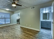 Thumbnail 3 of 14 - A room with a ceiling fan and wooden flooring. at The Link Apartments, Mesa, 85201