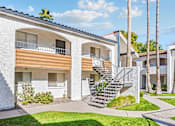 Thumbnail 8 of 12 - A white building with a balcony and a staircase at Tides on East Cactus Apartments, Arizona