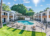 Thumbnail 9 of 12 - A sunny day at a resort with a pool and lounge chairs at Tides on East Cactus Apartments, Arizona, 85032