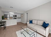 Thumbnail 4 of 28 - A modern living room with a white couch and a glass coffee table  at Tides on McDowell, Phoenix, 85035