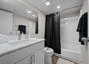 Thumbnail 5 of 28 - A bathroom with a white sink and a white toilet  at Tides on McDowell, Phoenix