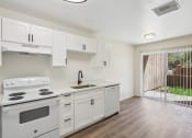 Thumbnail 2 of 15 - the preserve at ballantyne commons apartment kitchen with stove and sink and white cabinets