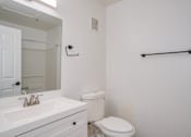 Thumbnail 9 of 15 - a bathroom with a sink toilet and a mirror