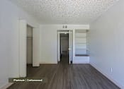 Thumbnail 11 of 51 - A room with a wooden floor and white walls.
