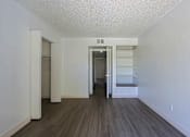 Thumbnail 46 of 94 - A room with a white ceiling and a wooden floor.