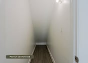 Thumbnail 20 of 51 - A hallway with platinum and cottonwood flooring.