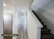 Thumbnail 13 of 51 - A staircase with a white railing and black steps.