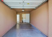 Thumbnail 42 of 51 - A long hallway with a white door at the end.