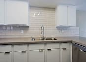 Thumbnail 42 of 94 - A kitchen with a sink and cabinets.