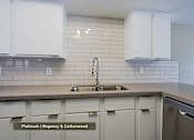 Thumbnail 2 of 51 - A kitchen with white cabinets and a sink.