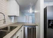 Thumbnail 41 of 94 - A modern kitchen with a stainless steel dishwasher and a sink.