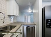 Thumbnail 3 of 51 - A kitchen with a stainless steel sink and dishwasher.