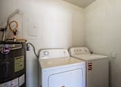 Thumbnail 35 of 94 - A washing machine and dryer in a small laundry room.
