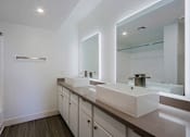 Thumbnail 34 of 94 - A bathroom with two sinks and a large mirror.