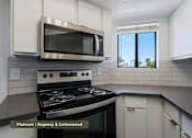 Thumbnail 1 of 51 - A modern kitchen with a stainless steel oven and microwave.