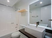 Thumbnail 22 of 94 - A white toilet sits next to a sink in a bathroom.