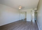 Thumbnail 23 of 94 - A room with a wooden floor and a white wall.