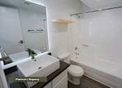 Thumbnail 7 of 51 - A bathroom with a sink, toilet, and bathtub.