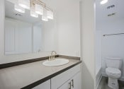Thumbnail 18 of 32 - a bathroom with a sink and a toilet and a mirror