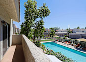 Thumbnail 37 of 51 - A pool area with a view of a residential area.