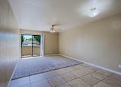 Thumbnail 13 of 94 - A room with a ceiling fan and sliding glass doors.